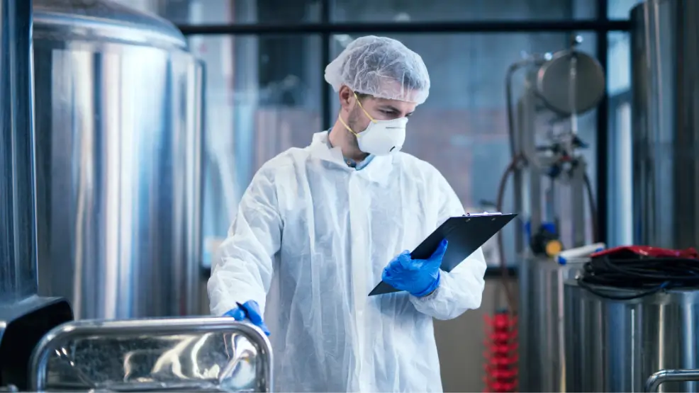 Food safety inspector conducting hygiene checks in a food processing facility in the UAE.